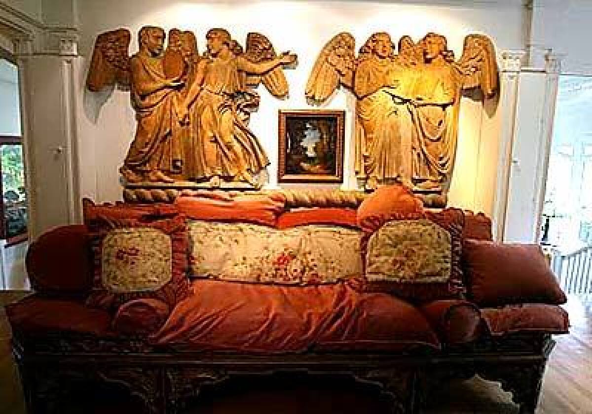Cathedral angels watch over a bed that once belonged to Mary Astor.