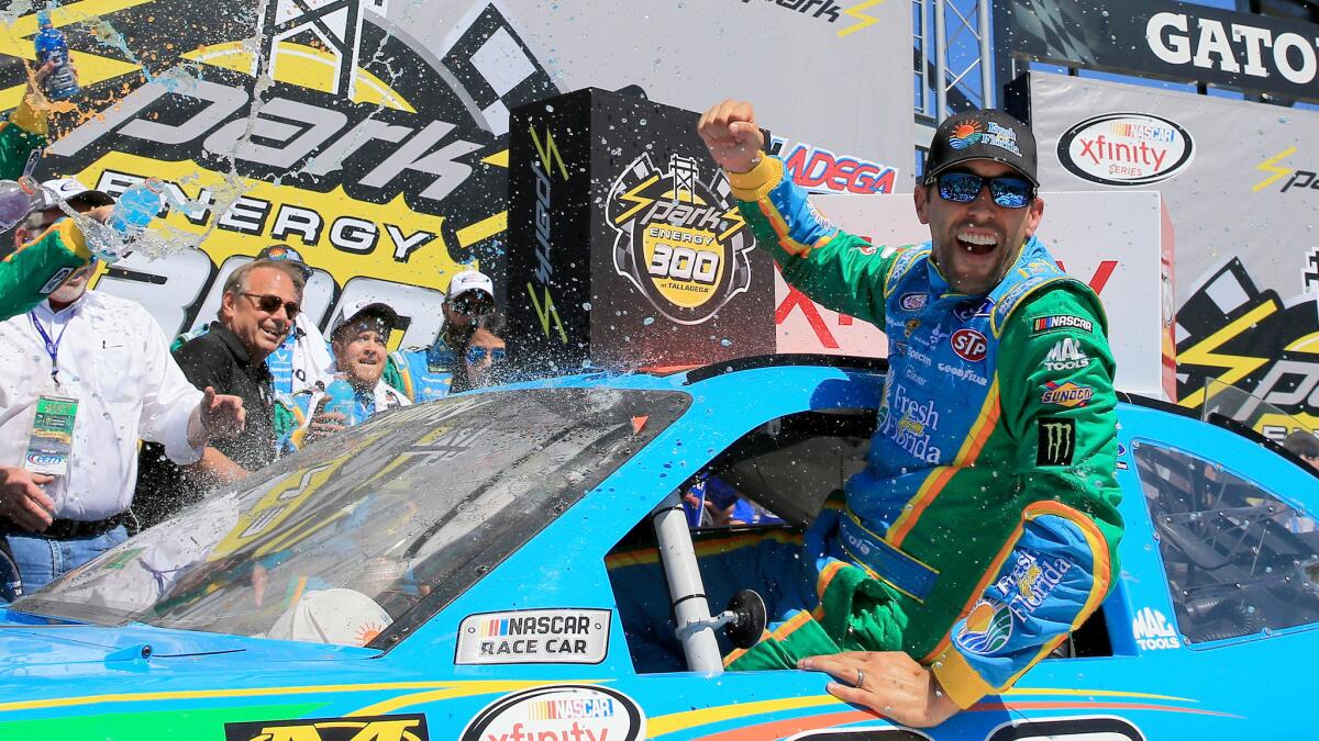 NASCAR driver Aric Almirola celebrates in Victory Lane after winning the Xfinity Series Sparks Energy 300 at Talladega Superspeedway on Saturday.