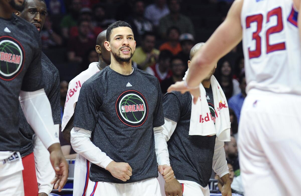 Newly acquired Clippers guard Austin Rivers stands in front of the bench during a timeout in a game Monday against the Boston Celtics at Staples Center.