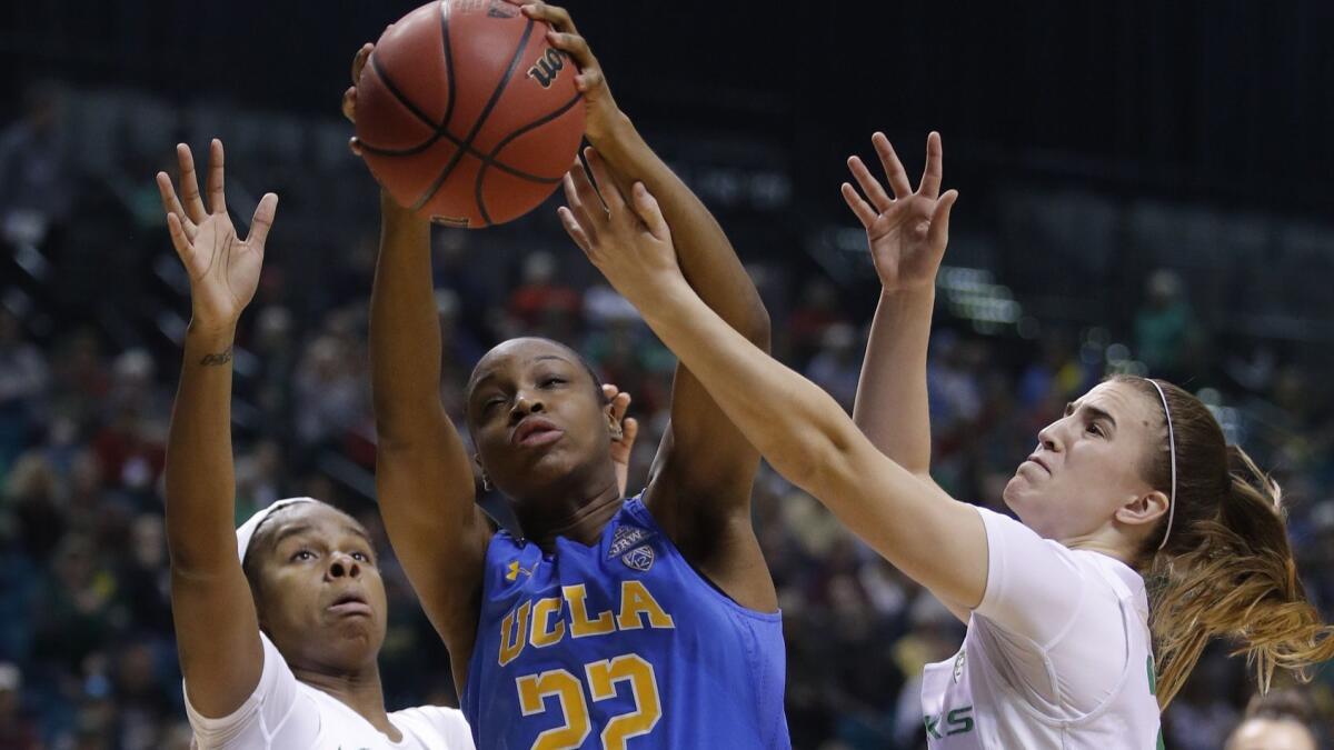 Oregon's Ruthy Hebard, left, UCLA's Kennedy Burke and Oregon's Sabrina Ionescu vie for a rebound during the first half of the semifinals of the Pac-12 women's tournament on Saturday in Las Vegas.