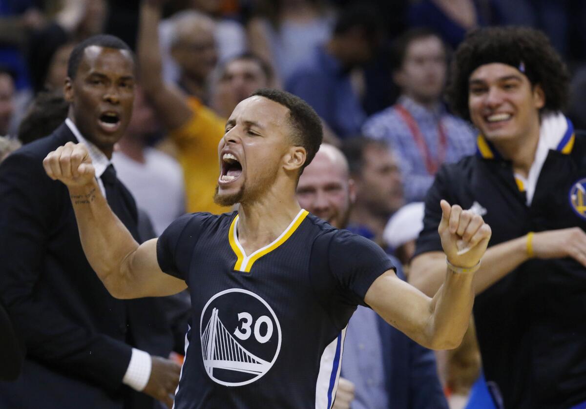 Warriors guard Stephen Curry (30) celebrates after hitting the game-winning shot in overtime against the Oklahoma City Thunder.