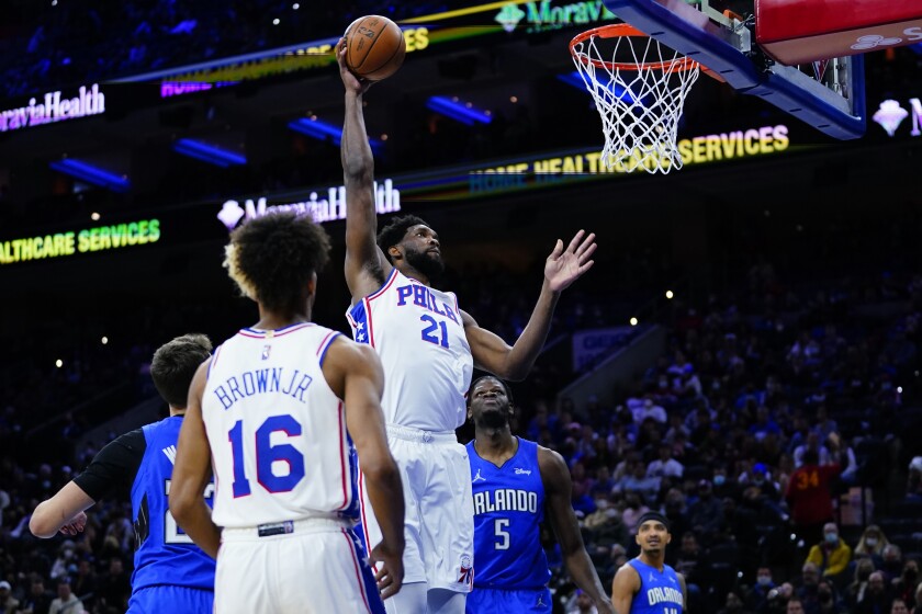 Philadelphia 76ers' Joel Embiid (21) goes up for a dunk during the first half of an NBA basketball game against the Orlando Magic, Wednesday, Jan. 19, 2022, in Philadelphia. (AP Photo/Matt Slocum)