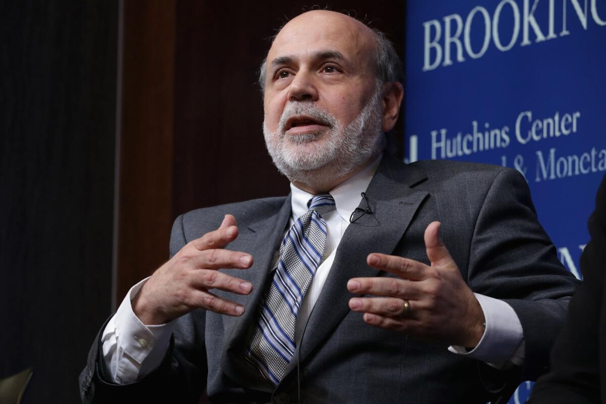 Former Federal Reserve Chairman Ben Bernanke launched a blog Monday with a post pushing back against critics of his low-interest-rate policies. Above, the ex-central banker at a panel discussion this month at the Brookings Institution in Washington.