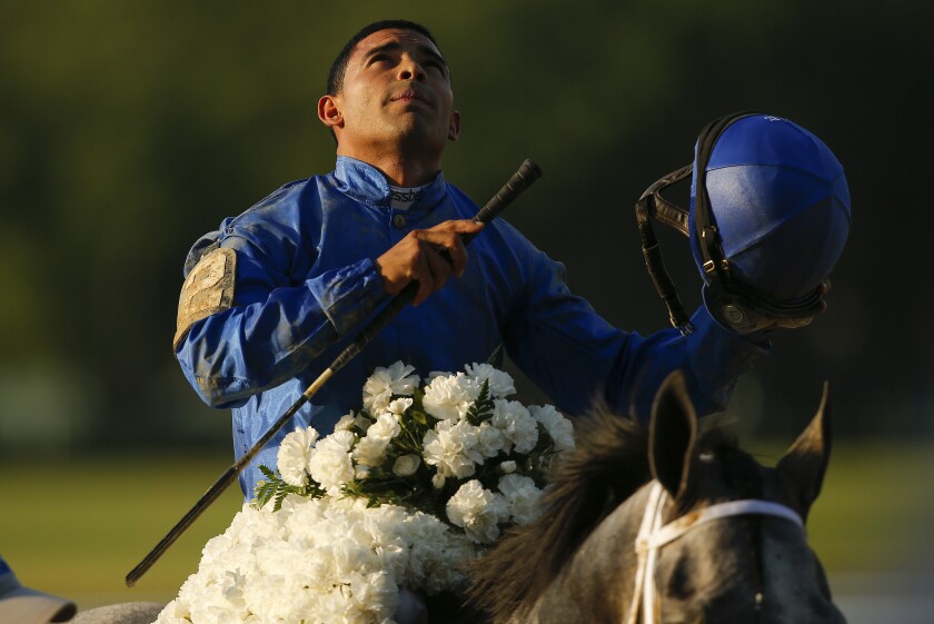Jockey Luis Saez reacts after winning the 153rd running of the Belmont Stakes horse race with Essential Quality (2), Saturday, June 5, 2021, At Belmont Park in Elmont, N.Y. (AP Photo/Eduardo Munoz Alvarez)