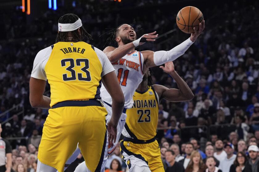 New York Knicks' Jalen Brunson (11) drives past Indiana Pacers' Myles Turner (33) and Aaron Nesmith (23) during the first half of Game 1 in an NBA basketball second-round playoff series, Monday, May 6, 2024, in New York. (AP Photo/Frank Franklin II)