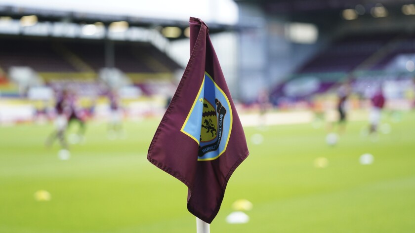 FILE - A corner flag showing the Burnley FC logo is seen ahead of the English Premier League soccer match between Burnley and West Ham United and at Turf Moor stadium in Burnley, England, May 3, 2021. Burnley’s shortage of players due to coronavirus cases and injuries has led to its Premier League match against Leicester being postponed. The league accepted Burnley’s case that it didn’t have enough squad members available to play their match on Saturday, Jan. 15, 2022. (AP Photo/Jon Super, file)