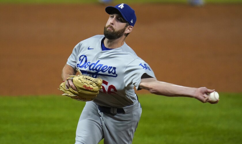 Dodgers relief pitcher Adam Kolarek throws against the Colorado Rockies on Sept. 17.