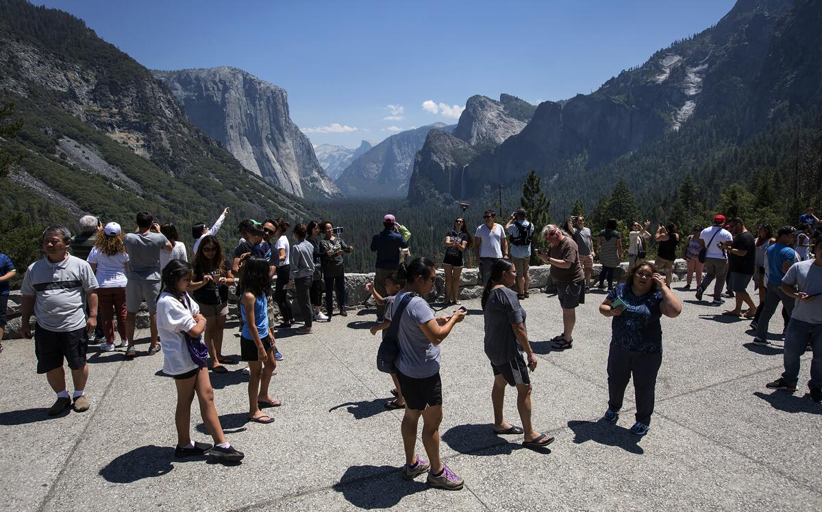 Yosemite National Park tourists visit Tunnel View on July 14, 2017. Trump administration proposals to make U.S. national parks more attractive to young people and improve the quality of National Park Service facilities have been met by fierce opposition by conservation groups and senior citizen advocates.