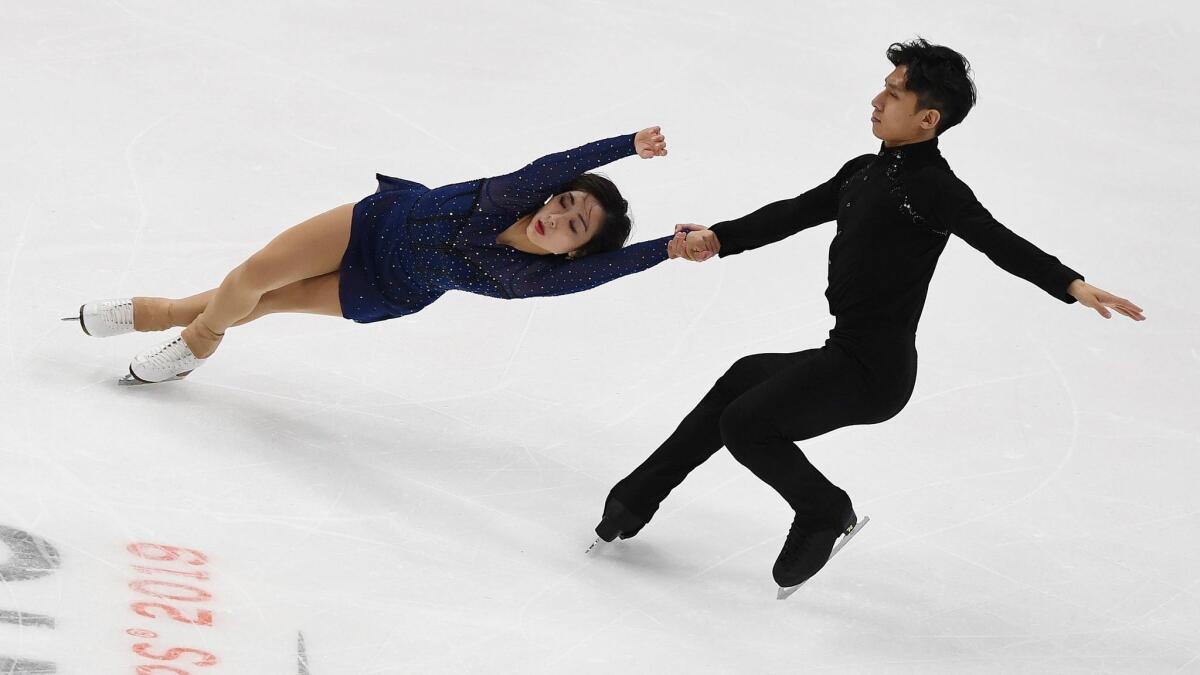 Wenjing Sui (left) and her partner Cong Han of China compete before winning the pairs competition during the ISU Four Continents Figure Skating Championship at the Honda Center on Saturday.