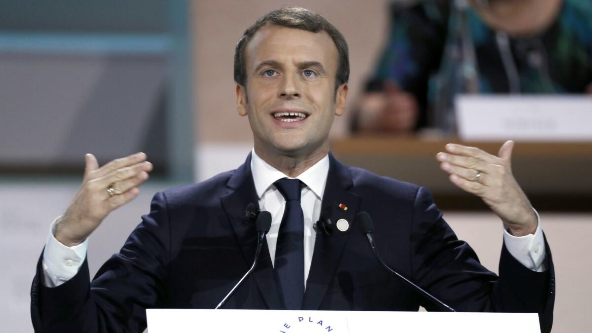 French President Emmanuel Macron delivers a speech as part of the plenary session of One Planet Summit in Boulogne-Billancourt, near Paris, on Dec. 12, 2017.