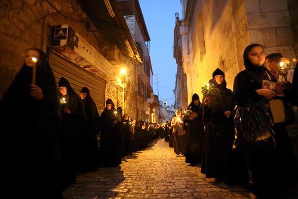 Greek Orthodox Christians walk from the Church of the Holy Sepulcher to Gethsemane Church along the Via Dolorosa in the old city of Jerusalem in a commemoration of the death and resurrection of Saint Maria.