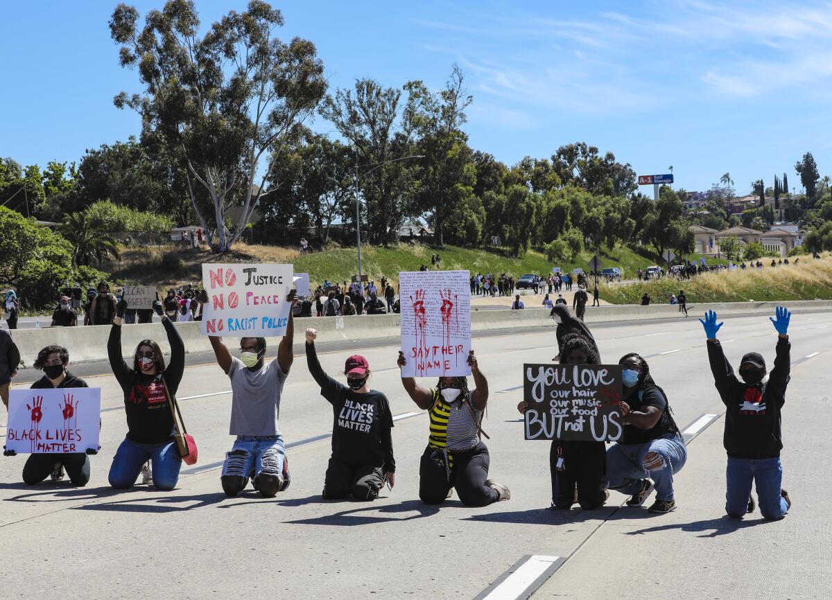 Protestors in support of calling for justice for George Floyd temporary blocked freeway lanes on Interstate 8 during a protest in La Mesa on Saturday.