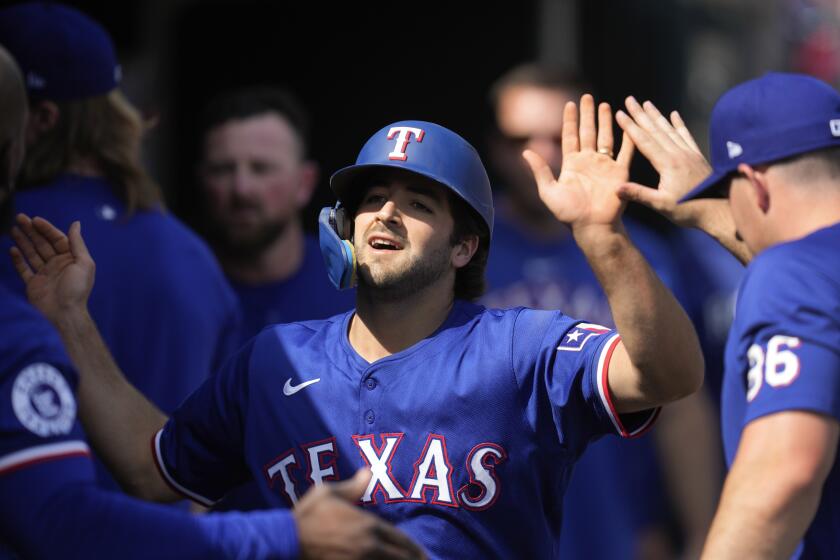 Texas Rangers' Josh Smith celebrates scoring against the Detroit Tigers in the ninth inning of a baseball game, Thursday, April 18, 2024, in Detroit. (AP Photo/Paul Sancya)