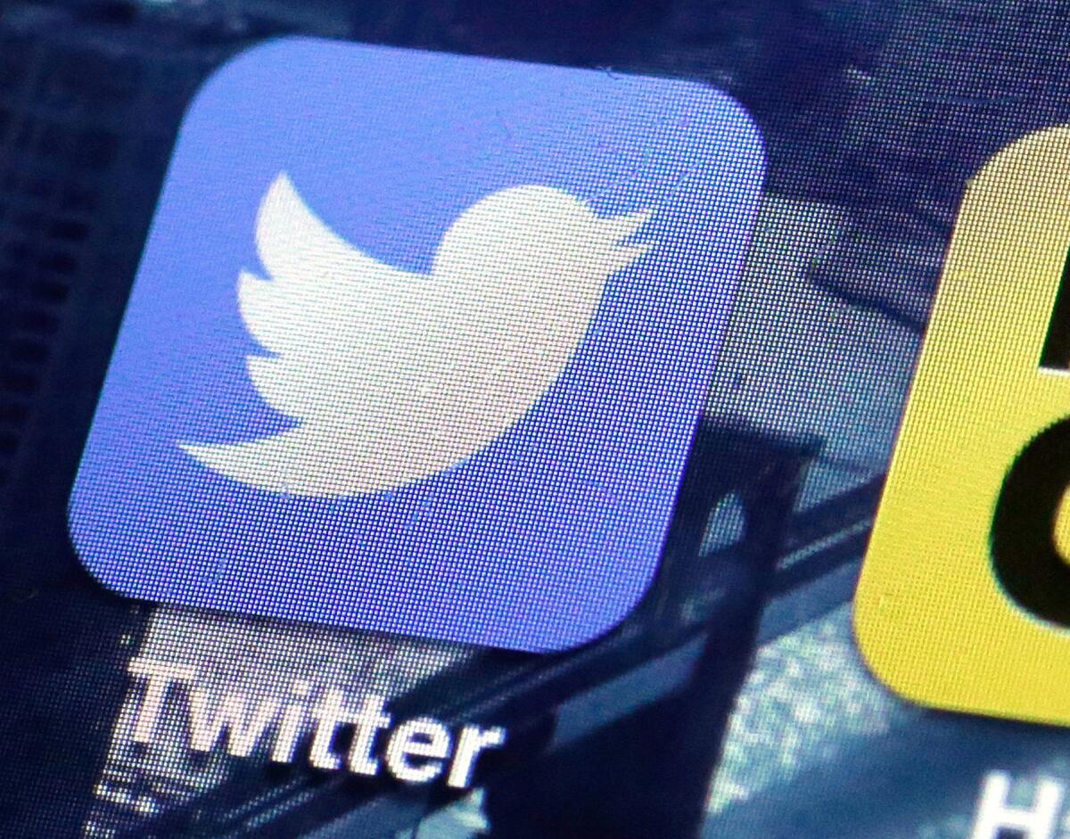 A Twitter app icon is shown on a smartphone screen. Four Twitter executives are leaving the San Francisco company.