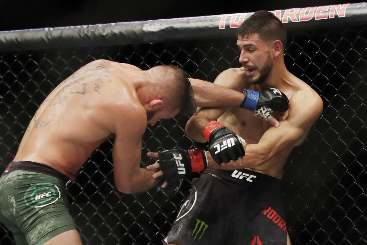 Jeremy Stephens, left, fights Yair Rodriguez during a featherweight mixed martial arts bout Friday, Oct. 18, 2019, at UFC Fight Night in Boston. (AP Photo/Elise Amendola)