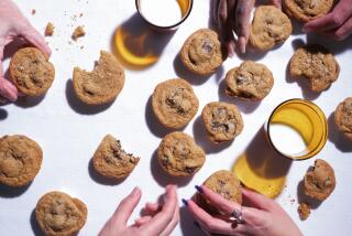 LOS ANGELES, CA - JANUARY 20, 2023: The Los Angeles Times test kitchen staff reach for chocolate chip cookies on January 20, 2023 at Los Angeles Times test kitchen in El Segundo, CA. The chocolate chip cookie is a featured recipe.