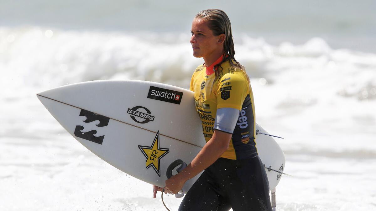 Courtney Conlogue emerges from the surf after competing in the third round of the Vans U.S. Open of Surfing on Wednesday.