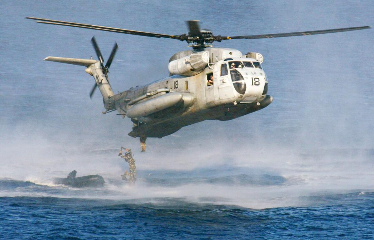In this Feb. 18, 2003, file photo, U.S. Marines and their Philippine counterparts jump from a CH-53D Sea Stallion helicopter at Ternate in Cavite province south of Manila. The U.S. Coast Guard says two Marine helicopters have collided off Oahu.