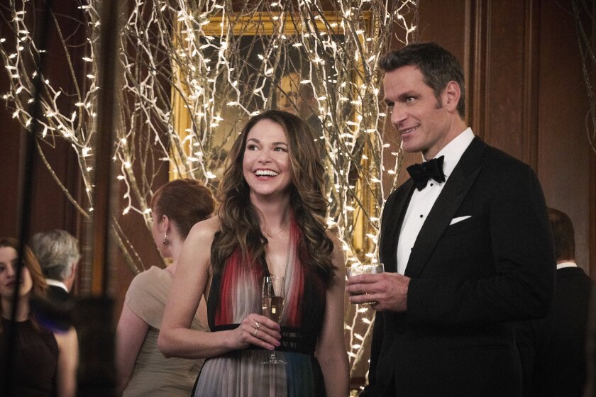 Sutton Foster, as Liza, and Peter Hermann, as her love interest Charles, enjoy a drink at a gala event in "Younger."