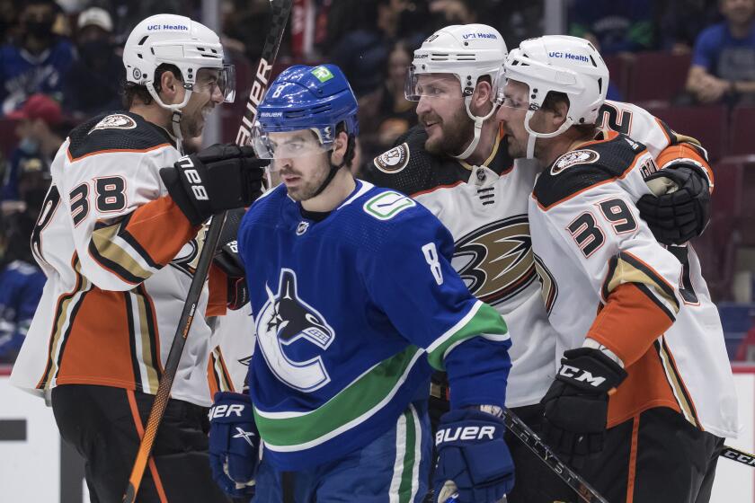 From left at top, the Ducks' Derek Grant, Nicolas Deslauriers and Sam Carrick celebrate Deslauriers' first-period goal.