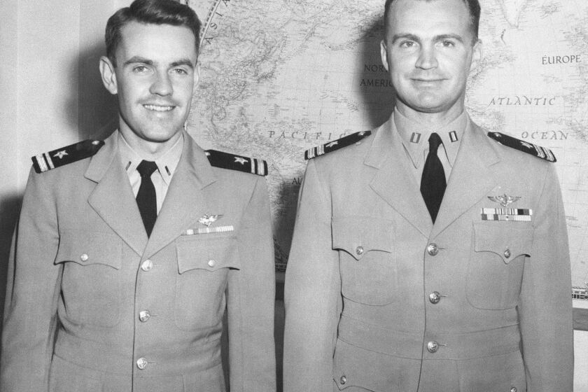 FILE - This July 15, 1955, photo shows plane commander Lt. R.H. Fischer, right, and co-pilot Lt. J/G D.M. Lockhart, in Kodiak, Alaska, after their Navy Neptune plane was shot down over the Bering Strait by Russian MiGs, June 22, 1955. Several crew members were injured but all 11 survived the crash landing on Alaska's St. Lawrence Island and were rescued by Siberian Yupik Eskimos living on the island, all of whom happened to be members of the Alaska National Guard. (AP Photo,File)