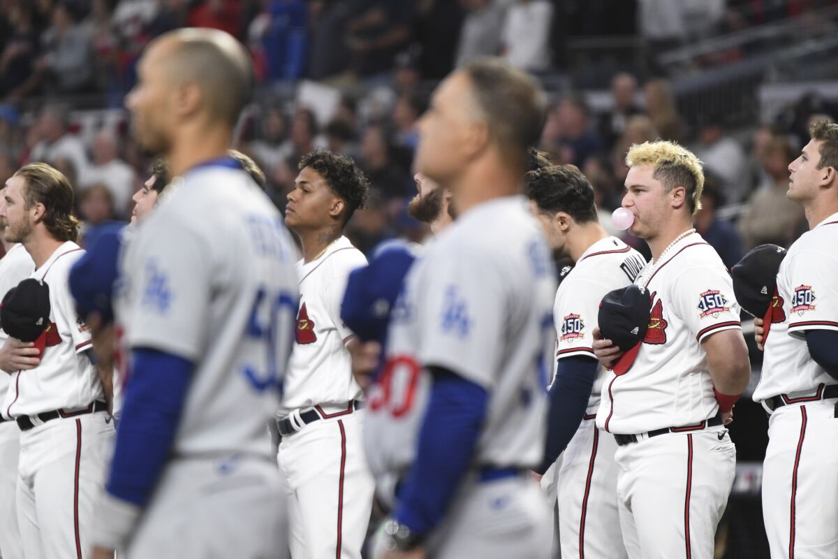 The Dodgers and Atlanta Braves stand for the national anthem before Game 1 of the NLCS.