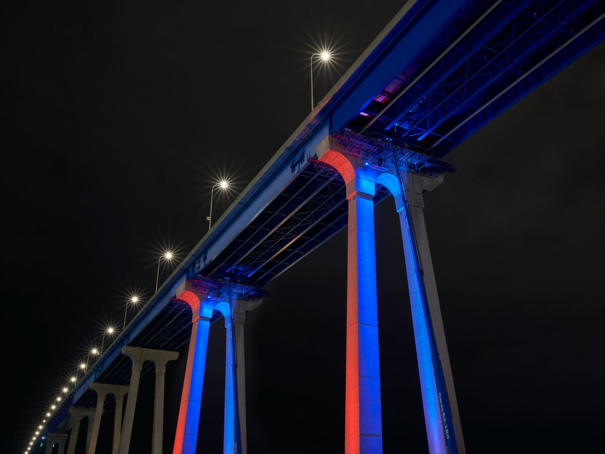 Two of the Coronado bridge's pillars are illuminated in various colors as part of a test to determine whether a full lighting of the bridge can work.