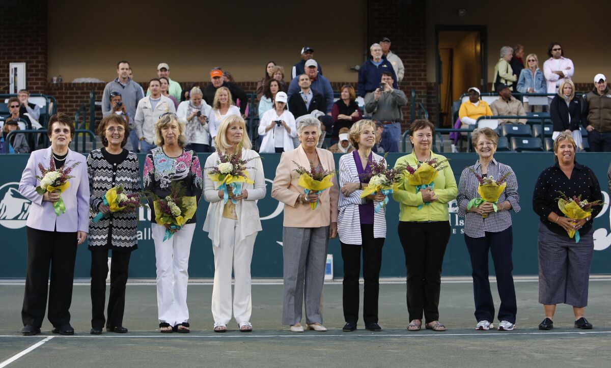 FILE - In this April 7, 2012, file photo, members of the original nine women, from left to right, Billie Jean King, Peaches Bartkowicz, Kristy Pigeon, Valerie Ziegenfuss, Judy Tegart Dalton, Julie Heldman, Kerry Melville Reid, Nancy Richey and Rosie Casals, who helped start the women's professional tennis tour are honored at the Family Circle Cup tennis tournament in Charleston, S.C. The nine signed a dollar contract 50 years ago, and it turned into millions for female tennis players. They were tired of being squeezed out of events by promoters and paid 10 times less than men. (AP Photo/Mic Smith, File)