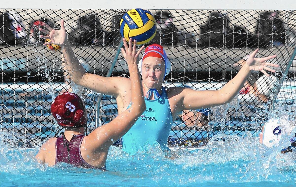 Corona del Mar High goalie Heidi Ritner, who recorded 22 saves, goes up to contest a shot by Laguna Beach's Sophia Lucas.