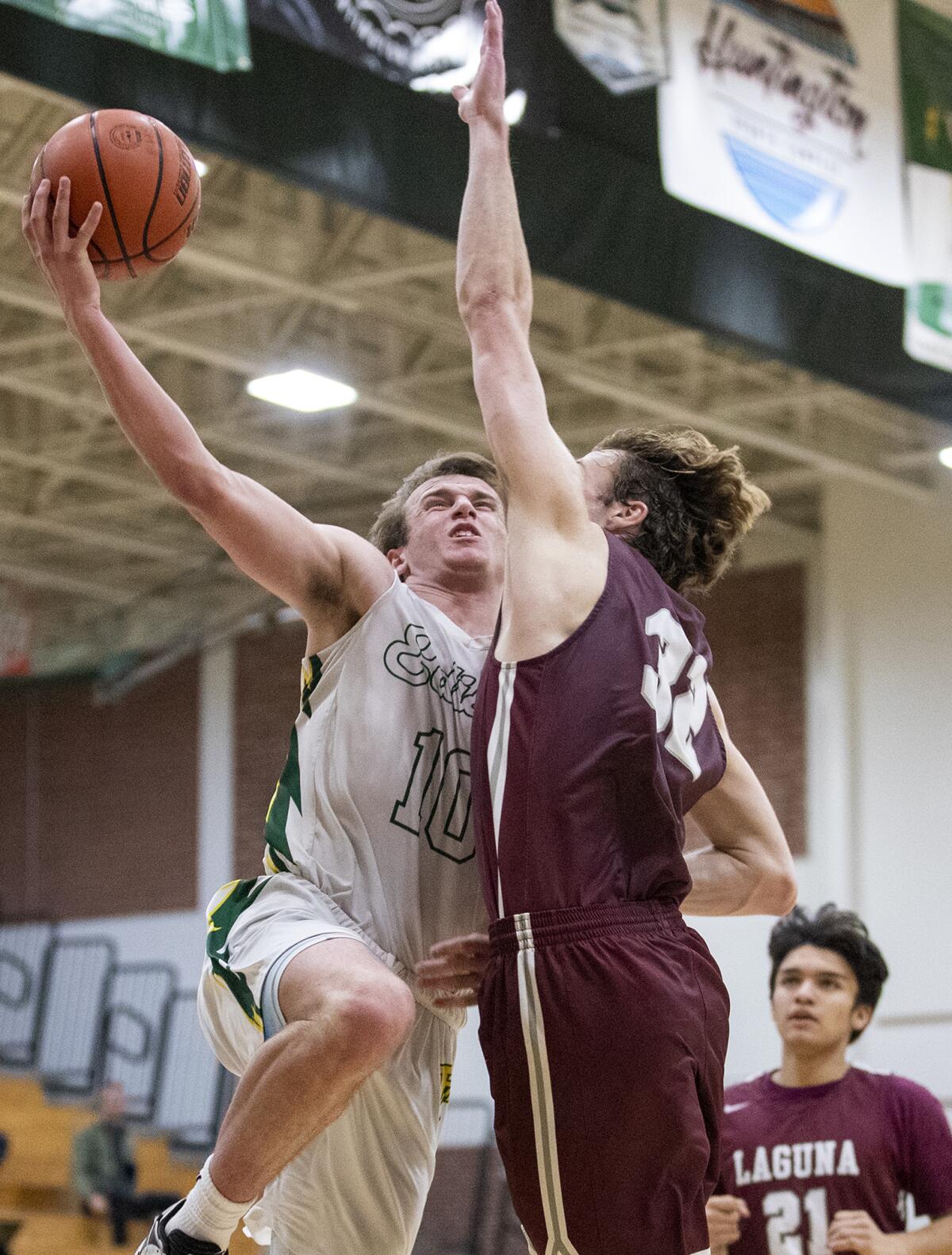 Edison's Tyler Hampton takes a shot against Laguna Beach's Jackson Sirianni during a Surf League game on Jan. 12.