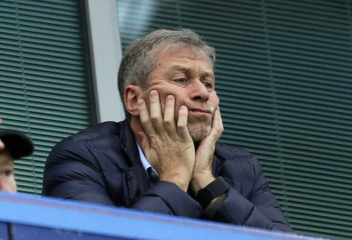 FILE - Chelsea soccer club owner Roman Abramovich sits in his box before their English Premier League soccer match against Sunderland at Stamford Bridge stadium in London, Dec. 19, 2015. Chelsea owner Roman Abramovich has on Saturday, Feb. 26, 2022 suddenly handed over the “stewardship and care” of the Premier League club to its charitable foundation trustees. The move came after a member of the British parliament called for the Russian billionaire to hand over the club in the wake of Russia’s invasion of Ukraine. (AP Photo/Matt Dunham, File)