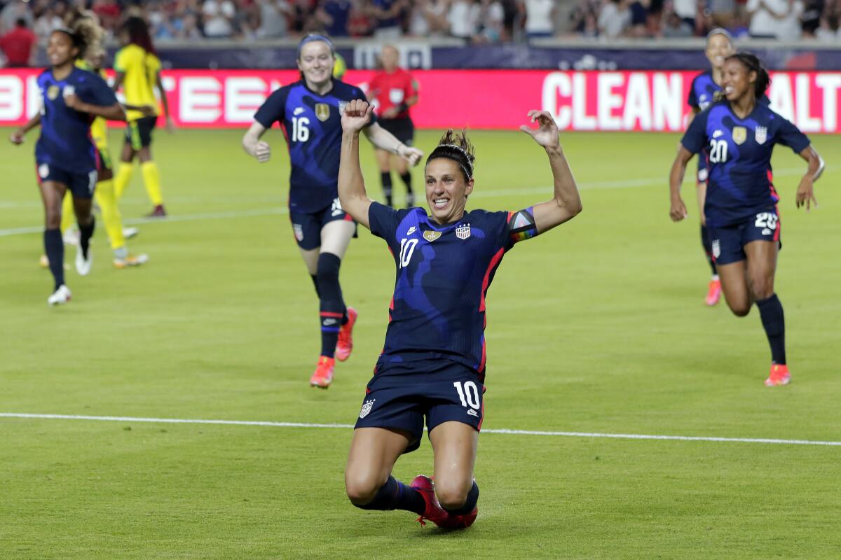 U.S. forward Carli Lloyd (10) slides on the turf after scoring in the first minute against Jamaica during the first half of their 2021 WNT Summer Series soccer match, Sunday, June 13, 2021, in Houston. (AP Photo/Michael Wyke)