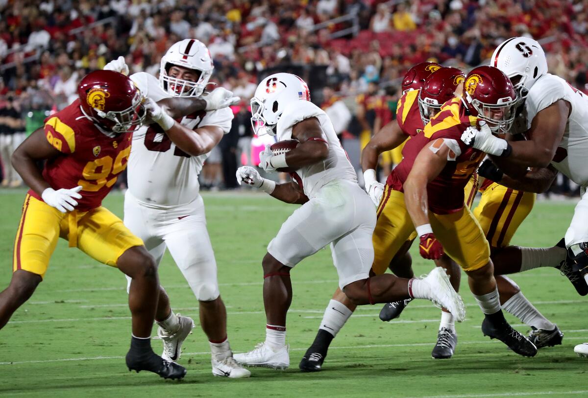 Stanford running back Nathaniel Peat runs between USC's Drake Jackson and Nick Figueroa for a touchdown.