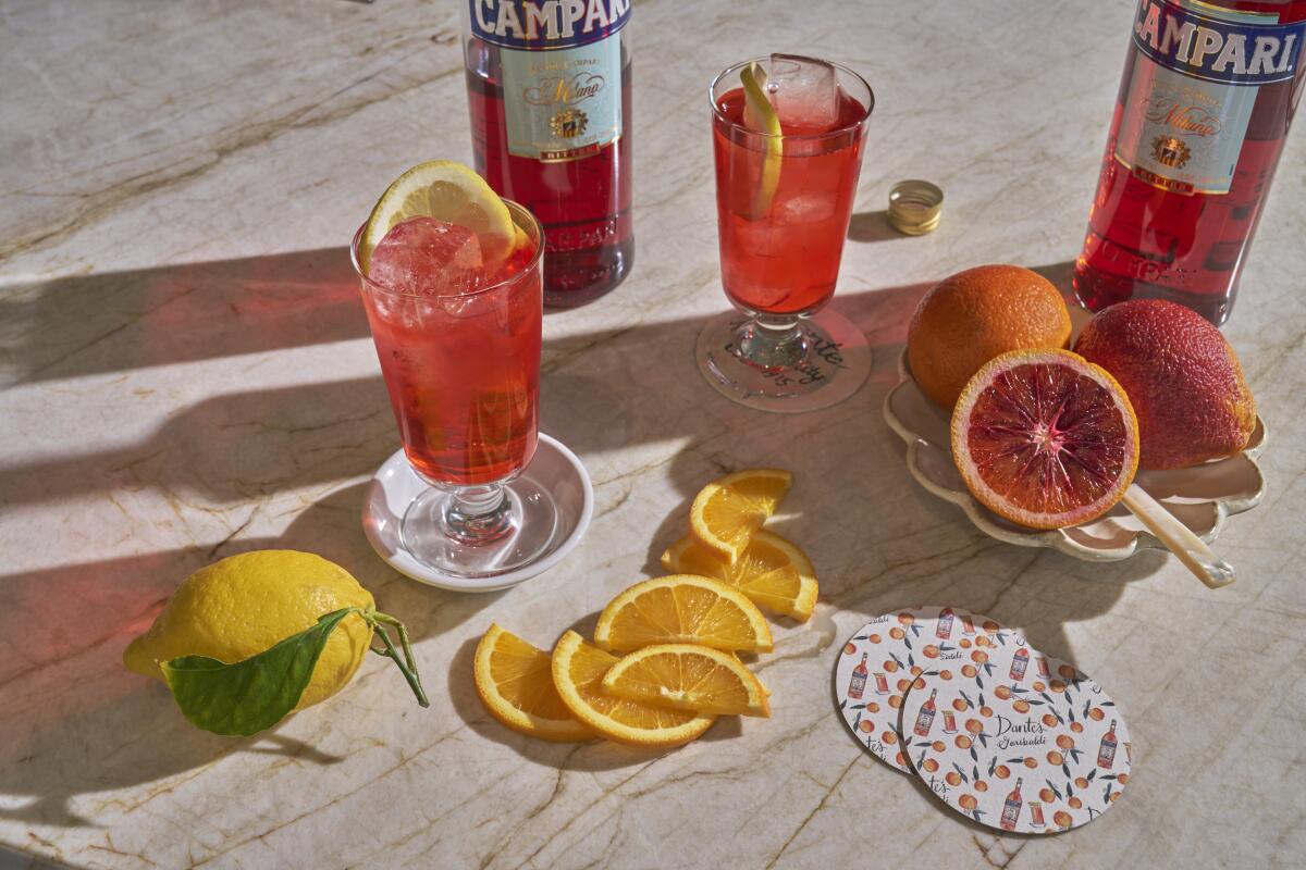 A selection of cocktails and fresh whole and sliced citrus fruits