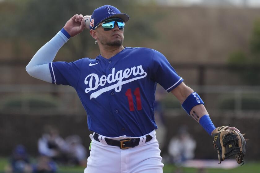 Dodgers shortstop Miguel Rojas warms up during the second inning of a spring training baseball game 