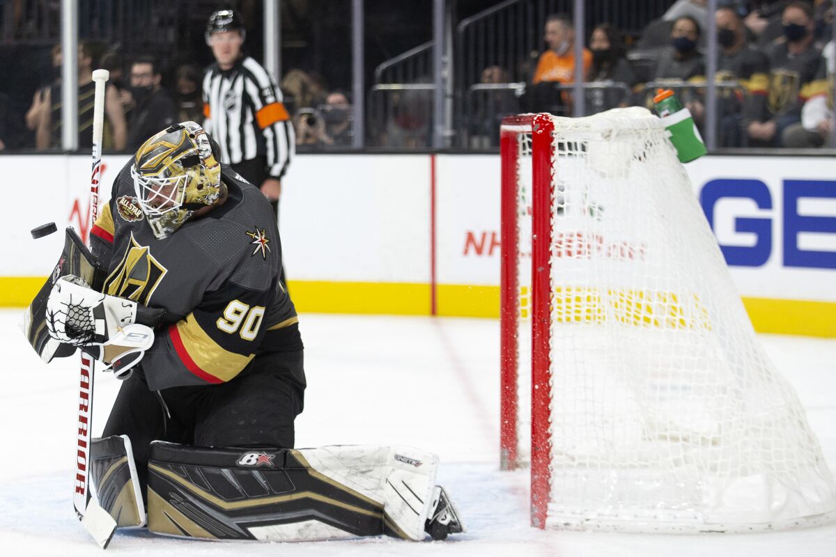 Vegas Golden Knights goaltender Robin Lehner (90) saves a shot on goal by the Calgary Flames during the first period of an NHL hockey game Sunday, Dec. 5, 2021, in Las Vegas. (AP Photo/Ellen Schmidt)