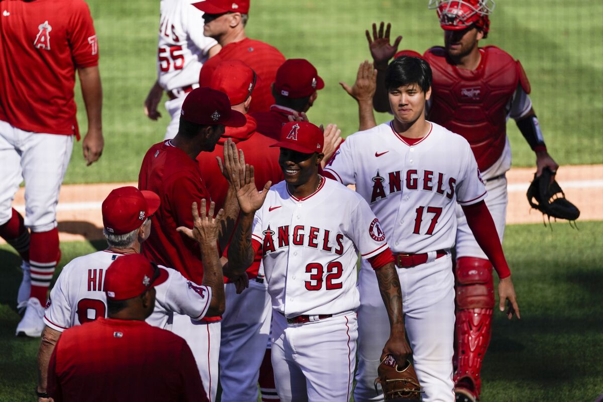 Angels relief pitcher Raisel Iglesias (32), designated hitter Shohei Ohtani (17) and the rest of the Angels celebrate.