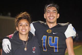 Crenshaw kicker/punter Roberto Salazar celebrates with sister, Citlali, after making game-winning field goal against Dorsey.