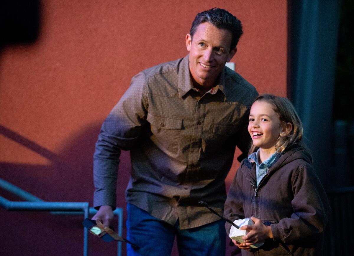 Sculptor Casey Parlette walks off stage with his son after being named Artist of the Year.