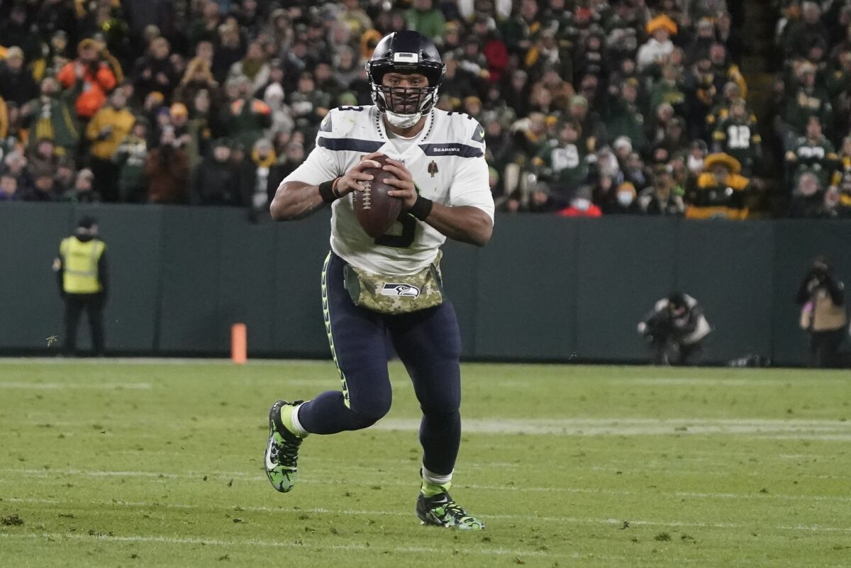 Seattle Seahawks' Russell Wilson scrambles during the second half of an NFL football game against the Green Bay Packers Sunday, Nov. 14, 2021, in Green Bay, Wis. (AP Photo/Morry Gash)