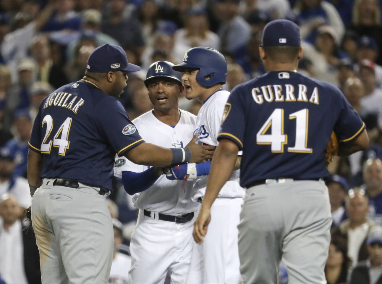Manny Machado and Brewers first baseman Jesus Aguilar confront each other after a 10th inning groundout.