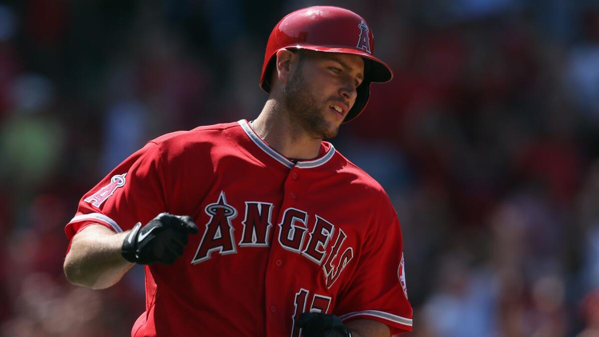 Angels catcher Chris Iannetta pumps his fist after hitting a solo home run in the eighth inning of the Angels' 4-3 win over the Kansas City Royals on Sunday afternoon.