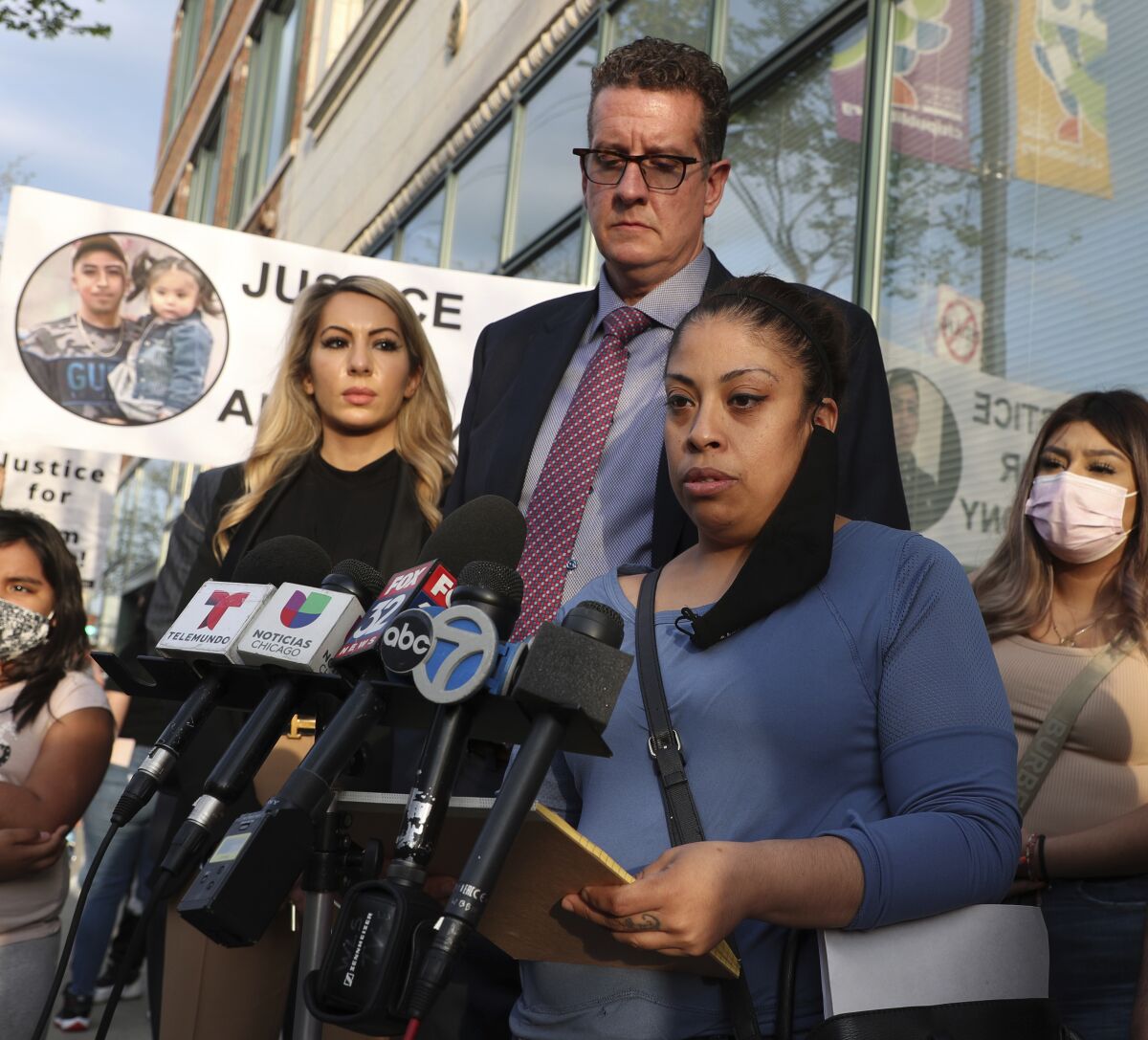 Veronica Alvarez, foreground, the mother of 22-year-old Anthony Alvarez, reads a statement to the media on Tuesday, April 27, 2021, after watching video of her son's fatal shooting. Her attorney Todd Pugh stands behind her. No charges will be filed against the Chicago police officers who fatally shot 13-year-old Adam Toledo and 22-year-old Anthony Alvarez during foot pursuits within days of each other last year, a prosecutor announced Tuesday, March 15, 2022. (Terrence Antonio James/Chicago Tribune via AP)