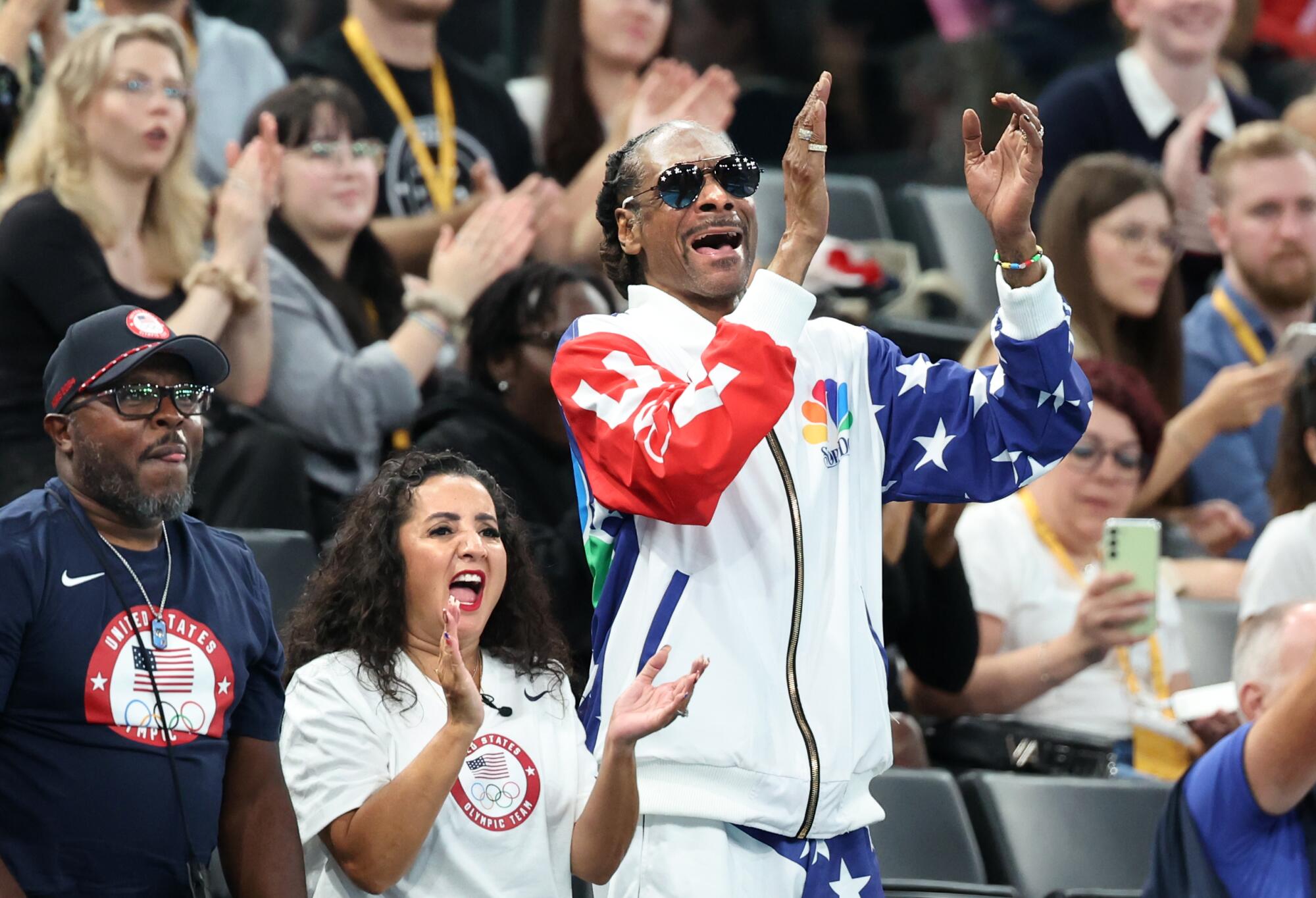 Rapper Snoop Dogg cheers during women's gymnastics qualifications at the Paris Olympics on Sunday.