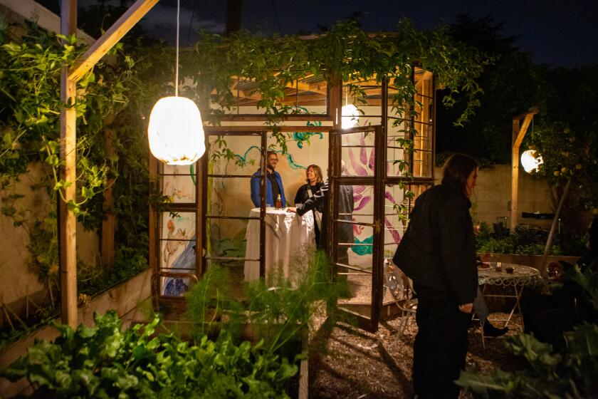 SANTA MONICA, CA - FEBRUARY 15: Art lovers gather in a green house in the backyard of a Santa Monica home for an exhibition preview party/dinner for Frieze LA on Tuesday, Feb. 15, 2022 in Santa Monica, CA. (Jason Armond / Los Angeles Times)