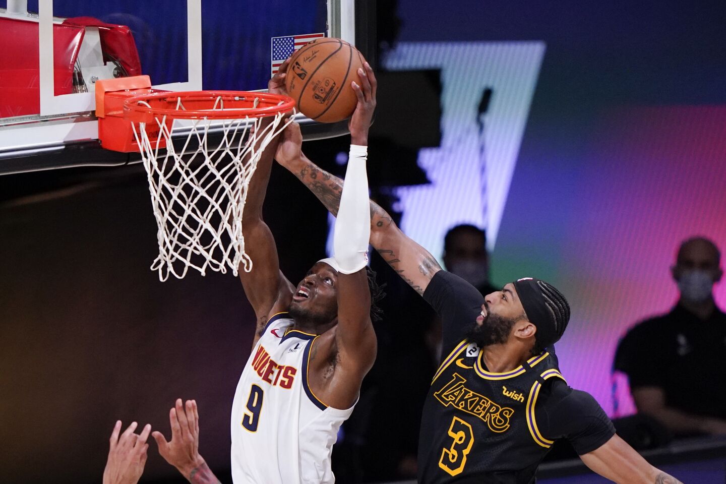 Lakers forward Anthony Davis tries to block a shot by Nuggets forward Jerami Grant during Game 2.