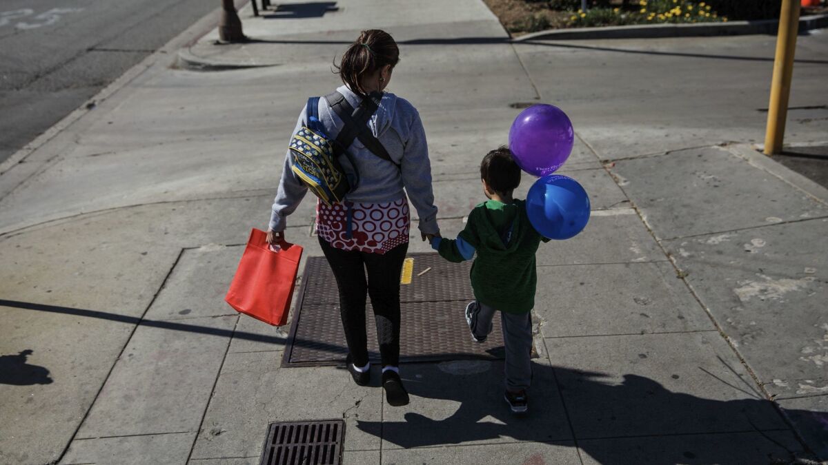 Veronica Coban, 35, walking with her son, 5-year-old Jaden. "I haven't been out in almost a week," Coban said. "I've been afraid to come out." The other day my friend said ICE came knocking at her door. She didn't open it but that made me anxious."