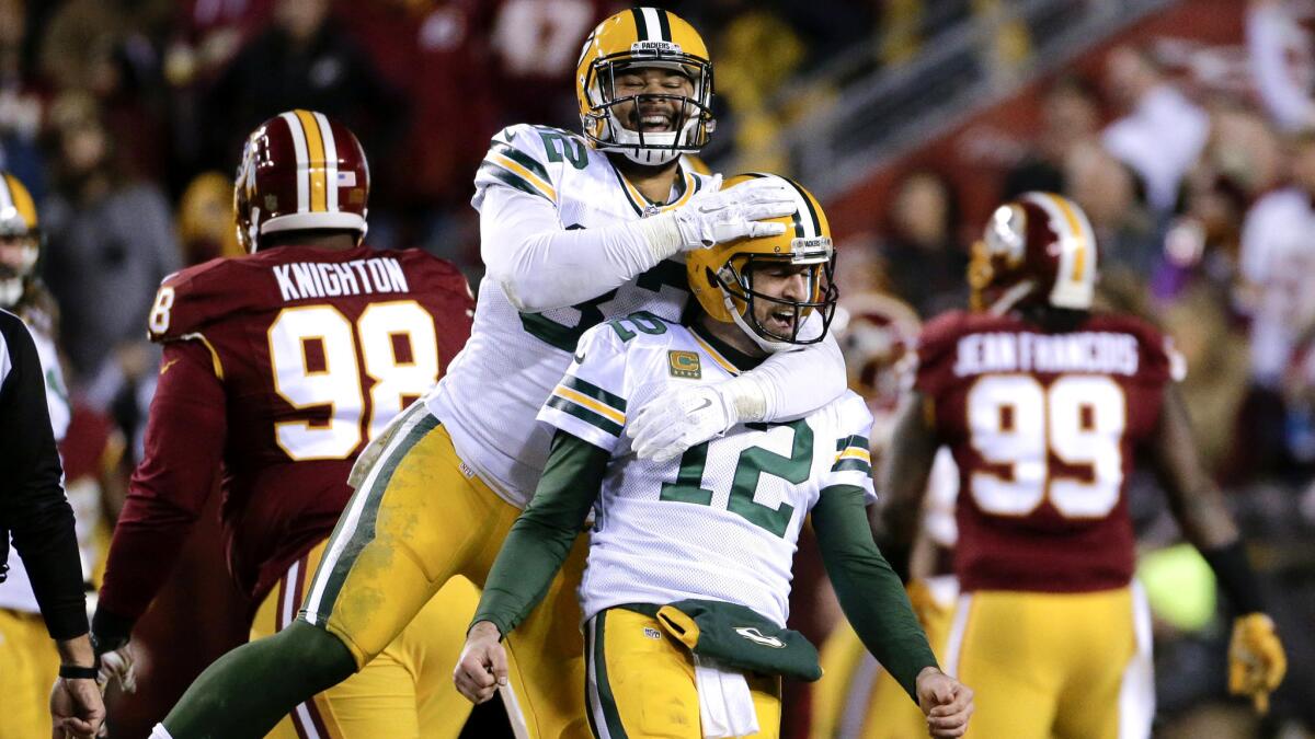 Packers tight end Richard Rodgers (82) celebrates with quarterback Aaron Rodgers (12) after wide receiver Davante Adams caught a touchdown pass against the Redskins on Sunday evening.