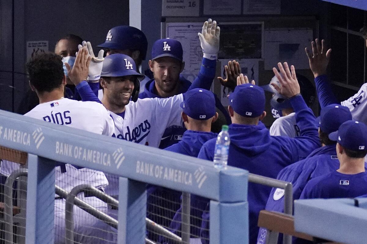 Chris Taylor is congratulated by his Dodgers teammates after hitting a solo home run during the first inning Tuesday.