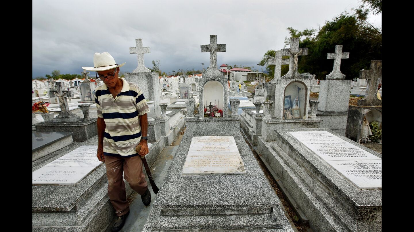 Heriberto Riveiro, 41, passes the gravesite of Leohermanijildo Cotte, who died because there was no electricity for his oxygen tank during Hurricane Maria. In the town of Lajas, on the southwest coast of Puerto Rico, elderly residents are most at risk in the days after the hurricane.